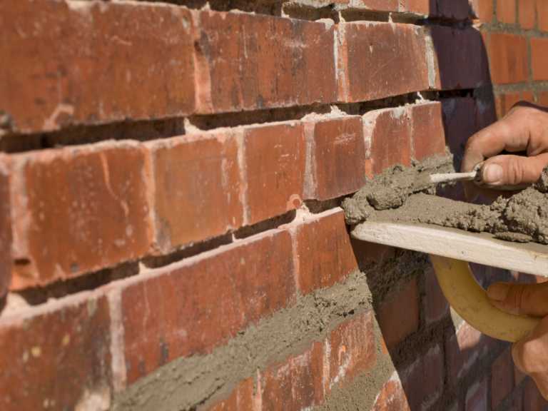tuckpointing brick wall removing concrete applying new concrete