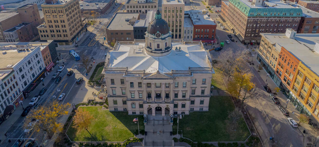 Aerial view of historic courthouse and surrounding buildings.