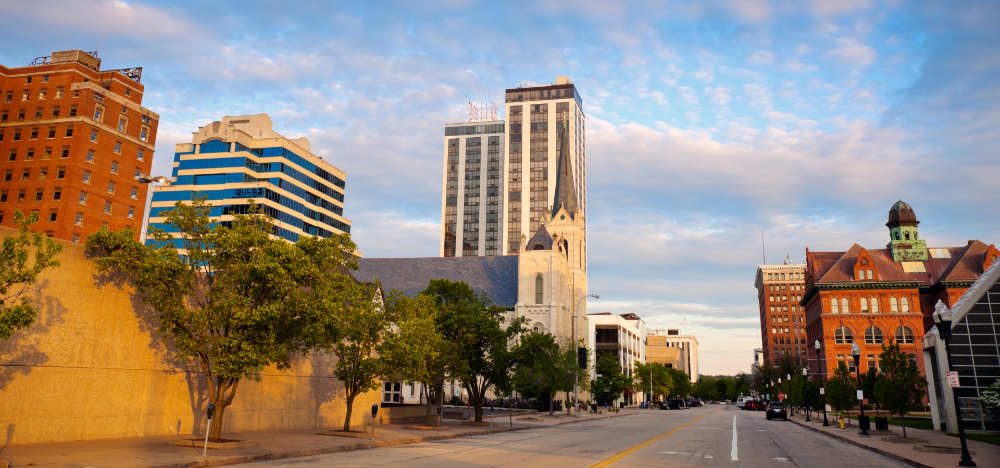 Downtown Peoria skyline with historic buildings and trees.
