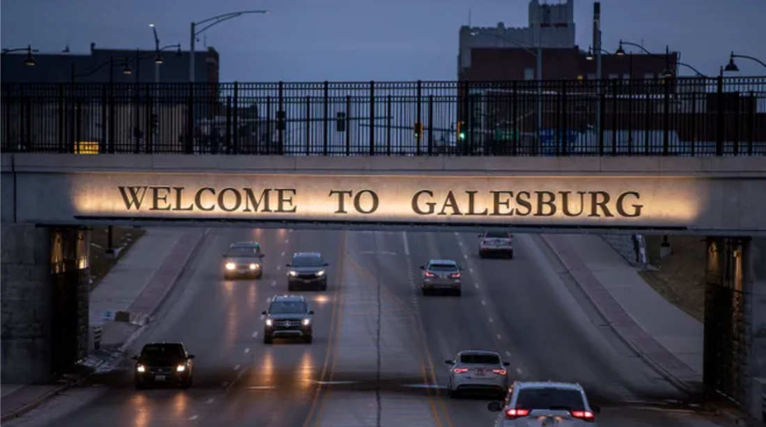 Welcome to Galesburg bridge over roadway with cars.