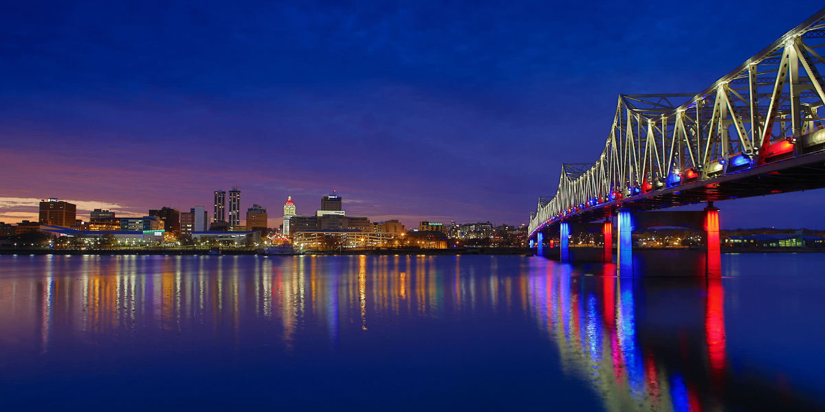 Night view of illuminated bridge and city skyline
